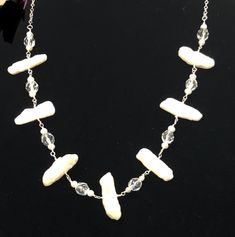 This artisan designed, hand wired-wrapped, antique Biwa pearl and vintage crystal necklace is a new trend for traditional pearls. Set with sterling silver chain, which has an adjustable length, it will be a classic addition  to your jewelry collection. Biwa pearls were cultivated from mussels in Biwa Lake, located in Japan. They have been produced since the 1930's. It can adjust from 16-18 inches, to accommodate many types of  necklines. Thanks to Coco Chanel's influence, pearls can be worn anytime,  anywhere, and with anything...they are timeless.  Please also look for the matching Biwa pearl earrings in my shop. Thank you for browsing! Types Of Necklines, Biwa Pearls, Length Necklace, Artisan Design, New Trend, Vintage Crystal, Silver Pearls, Sterling Silver Chains, Crystal Necklace