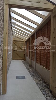 an empty walkway between two wooden buildings