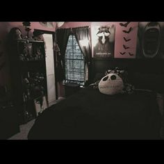 a bedroom decorated in black and white with halloween decorations