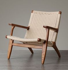 a woven chair on a wooden floor