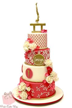 a three tiered cake with flowers on it's top and the word congratulations written on