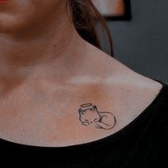 a woman with a cat tattoo on her chest