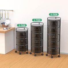 three tiers are shown in front of a white wall with green signs on it