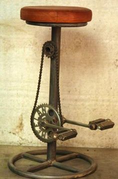 an old fashioned stool with gears attached to it