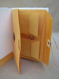 an open folder with some paper on the inside and one door opened to reveal something