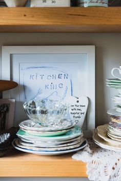 a shelf filled with lots of plates and cups