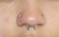 the nose has three piercings on it