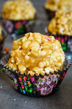 some cupcakes with caramel topping on top are sitting next to each other