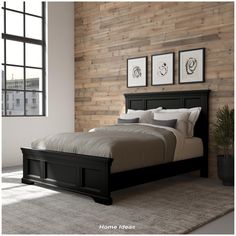 a bedroom with wood paneled walls and a bed in the middle, along with two framed pictures on the wall