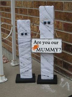 two white marble blocks with faces and words on them that say are you our mummy?