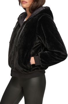 Plush faux fur feels luxurious in this laid-back hoodie jacket accented with grosgrain ribbon drawstrings and trim. 23" length Partially lined Ribbed cuffs and hem 100% polyester faux fur Spot clean Imported Fall Hooded Faux Fur Jacket With Fur Trim, Fall Faux Fur Hooded Jacket With Faux Fur Trim, Fall Hooded Jacket With Faux Fur Lining, Hooded Faux Fur Outerwear With Plush Lining, Fur Hooded Jacket, Faux Fur Hooded Jacket, Black Faux Fur Jacket, Marc New York, Black Faux Fur