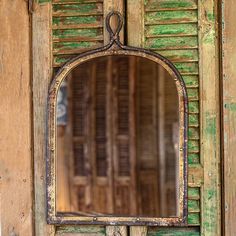 an old wooden door with a mirror on it