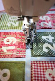 a close up of a sewing machine on a table with quilted placemats