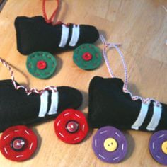 three toy roller skates made out of felt and buttons on a wooden table top