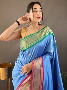 This festival season, elevate your ethnic fashion game with our outstanding sky blue zari weaving paithani silk reception wear saree. Made from luxurious silk material, this breathtaking saree showcases a mesmerizing sky-blue color that will instantly catch everyone's attention. The saree features intricate zari weaving work, adding a touch of elegance and sophistication to its overall design.
One of the highlights of this saree is its rich pallu with golden motifs, which are scattered all over Blue Paithani Silk Saree With Self Design, Blue Paithani Silk Saree With Unstitched Blouse, Blue Meenakari Saree For Navratri, Blue Paithani Silk Saree With Zari Work, Traditional Light Blue Saree With Unstitched Blouse, Blue Paithani Silk Saree For Festivals, Blue Meenakari Katan Silk Saree, Blue Paithani Silk Dupatta For Festivals, Blue Paithani Silk Traditional Wear For Navratri