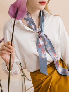 Elevate your wardrobe with the captivating beauty of our "Datura" silk twilly skinny scarf, a stunning accessory inspired by the delicate blooms of the darling darura flower, also known as angel's trumpet. The design embodies the voice of nature, immersing you in its ethereal beauty and transporting you to a realm of tranquility and peace. Made from premium quality silk satin, this skinny scarf is perfect for a hair scarf style. It can also drape elegantly around your neck, immersing you in its Elegant Blue Silk Scarf For Spring, Trendy Spring Neckwear For Gifts, Feminine Silk Scarf As Spring Gift, Feminine Silk Scarf For Spring Gift, Chic Blue Silk Scarf As Gift, Chic Blue Scarves For Gifts, Feminine Scarves As Summer Gifts, Chic Neckwear For Spring Gifting, Feminine Scarves For Spring Gift