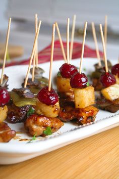 several skewered food items on a white plate