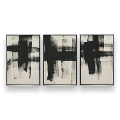 three black and white paintings hanging on a wall