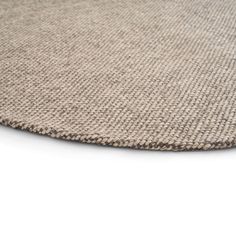 a close up view of an area rug on a white surface with no one in it