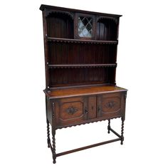 an old fashioned wooden hutch with two drawers on one side and a mirror on the other