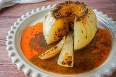 an onion dish is served on a white plate