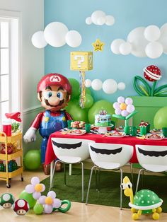 a mario birthday party with balloons, decorations and table cloths in the shape of toades