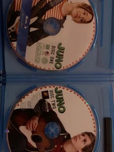 two dvd's sitting on top of each other in blue plastic cases with the covers pulled down