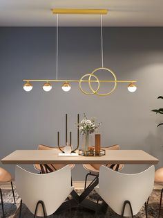 a dining room table with chairs and lights