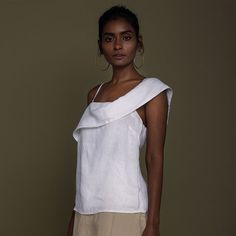 Elevate your wardrobe with The Wandering Wave Top from Reistor. The straight fit and asymmetrical neckline create a sophisticated silhouette. Embrace the unique design with a draped sleeve on one side and a chic strap on the other. This stylish top offers versatile styling options for various occasions. Crafted from hemp, it combines comfort with elegance, making it a must-have in your collection. Discover timeless style with Reistor's Wandering Wave Top. Modern Asymmetrical One Shoulder Top, Fitted One Shoulder Foldover Top For Summer, Fitted One-shoulder Foldover Top For Summer, Fitted One Shoulder Top With Foldover Top For Summer, Fitted One Shoulder Top With Foldover Design For Summer, Elegant Summer Tops With Straight Neckline, Elegant White Blouse With Asymmetrical Neckline, Elegant Tops With Straight Neckline For Summer, Elegant Straight Neckline Summer Tops