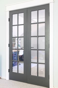 two doors with glass on each side in a room