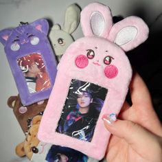 a person holding up a cell phone case with an image of a bunny on it