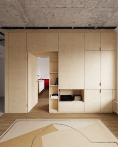 an empty room with wooden cabinets and carpet