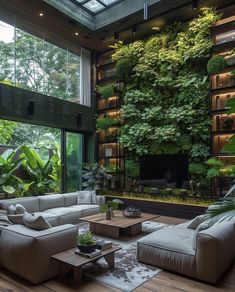 a living room filled with furniture and lots of greenery on the wall behind it