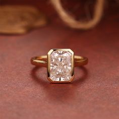 a gold ring with a white diamond in it