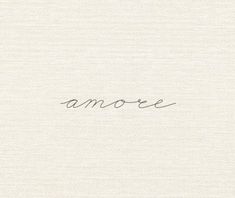 the word amoe is written in cursive handwriting on a white paper background