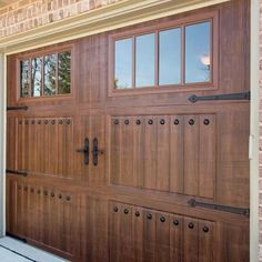 a large wooden garage door with windows