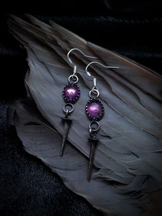 The perfect balance of light and dark, these delicate Amethyst and Vintage Coffin Nail Earrings exude vintage glamour with a modern edge that speaks to your inner dark goddess. Both glowy and tasteful, these earrings will be the perfect statement piece for an elegant, refined look. These earrings come on sterling silver ear wires for lobe piercings. Witch Jewellery, Dark Feminine Earrings, Goth Ear Piercings, Goth Accessories Jewellery, Gothic Drop Earrings Pierced, Vampire Style Dangle Earrings, Gothic Black Drop Earrings, Silver Gothic Dangle Earrings, Gothic Dangle Metal Plug Earrings