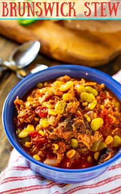 a blue bowl filled with stew and beans