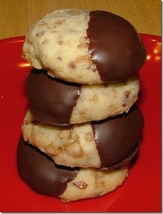 three chocolate covered cookies stacked on top of each other