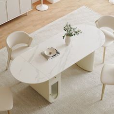 a white table with four chairs around it