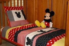 a mickey mouse bed with red and black sheets