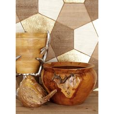 three wooden bowls with metal handles on a table