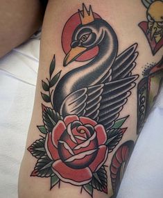 a black bird with a crown on it's head and roses around its neck