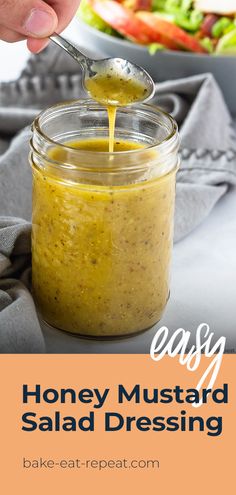 honey mustard salad dressing in a jar with a spoon sticking out of it and text overlay that reads easy honey mustard salad dressing