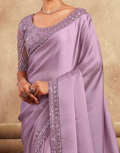 COLOR : Mauve FABRIC : Saree - Satin Silk, Blouse - Satin Silk & Net WORK : Resham Embroidery, Stones, Sequins, Lace BorderOCCASION : Wedding, Engagement, Party Wear, Festival, Sangeet NOTE : The outfit includes blouse and saree only. Petticoat is not included. READY-TO-WEAR : No STITCHING : Available as semi-stitched fabric, can be stitched using standard size option (+$30). Note: There might be a slight color variation due to lighting and flash used during photoshoot. The bright shade seen is Silk Saree Designs Party Wear, Wedding Pre-draped Chinon Saree With Embroidered Border, Wedding Embellished Art Silk Embroidered Fabric, Embellished Embroidered Fabric For Wedding, Fitted Party Blouse With Embroidered Border, Reception Georgette Sets With Embroidered Border, Embroidered Border Blouse Piece For Wedding, Embellished Fitted Saree For Celebration, Fitted Georgette Lehenga With Embroidered Border