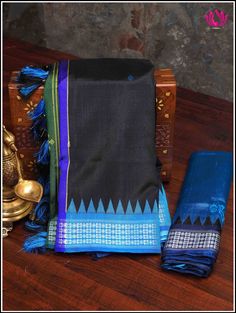 Berhampuri silk was introduced at Berhampur town in 14th century AD by the Mohuri Kings. It is known as ‘Silk City’ for its pure silk weaves. This Berhampuri silk saree is one of the traditional weaving and handloom heritage from Odisha. A vibrant Berhampuri pure silk saree in hues of black and blue with extended pallu - double anchal is just enough to steal any special occasion. The colorful pallu boasts traditional buttas. Handmade custom tassels adds grace to the saree. Blouse - Unstitched. F Black Paithani Silk Handloom Dupatta, Black Handloom Paithani Silk Dupatta, Black Raw Silk Traditional Wear For Puja, Festive Saree With Border For Rituals, Raw Silk Saree With Weaving Work For Rituals, Black Tussar Silk Saree With Weaving Work, Rituals Raw Silk Saree With Weaving Work, Traditional Wear With Border For Diwali Rituals, Traditional Wear For Diwali With Border Details