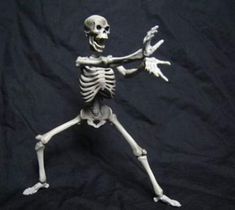 a skeleton is standing on one leg and holding his arms out in the air with both hands