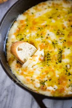 a skillet filled with cheese and bread