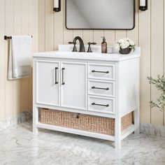 a white bathroom vanity with a mirror above it