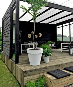 an outdoor deck with potted plants on it